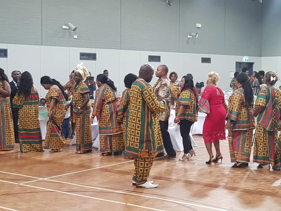 AKAA community celebrating in traditional Liberian cultural dress